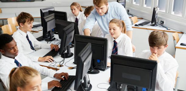 teenage students wearing uniform studying in it class 1
